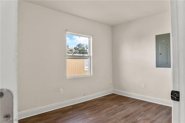 unfurnished room featuring hardwood / wood-style floors and electric panel