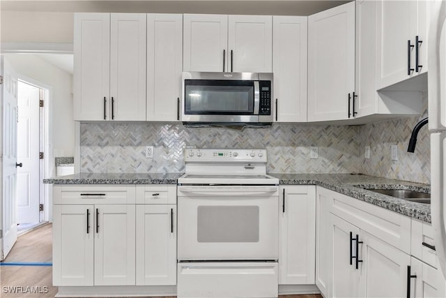 kitchen with white cabinets, sink, white electric stove, and light stone counters