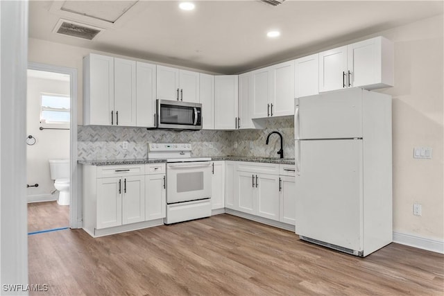 kitchen featuring sink, white appliances, white cabinets, and light hardwood / wood-style flooring