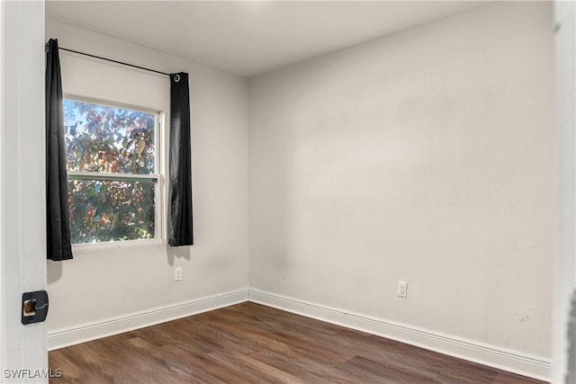 unfurnished room featuring dark wood-type flooring