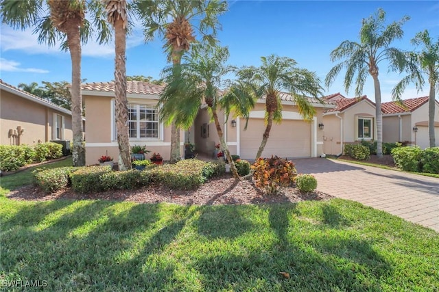 mediterranean / spanish home with a garage and a front lawn