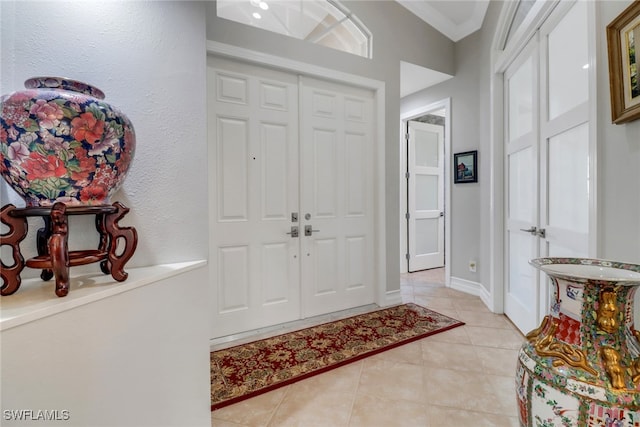 tiled foyer with ornamental molding