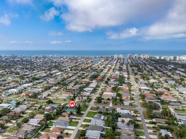 704 107th Ave N, Naples, FL 34108 - aerial overview of property's location with a large body of water and nearby suburban area