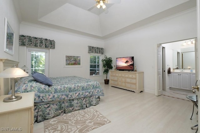 704 107th Ave N, Naples, FL 34108 - bedroom with light wood-style floors, ensuite bathroom, a ceiling fan, baseboards, and a high ceiling