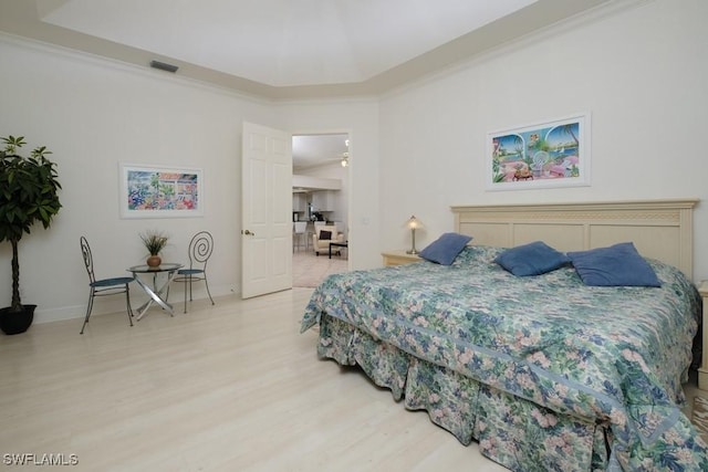 704 107th Ave N, Naples, FL 34108 - bedroom featuring light wood finished floors, baseboards, and crown molding