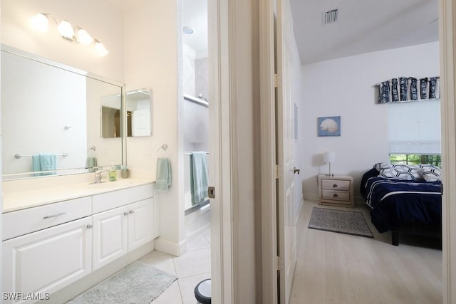 704 107th Ave N, Naples, FL 34108 - full bath with vanity, ensuite bath, baseboards, tile patterned flooring, and a shower