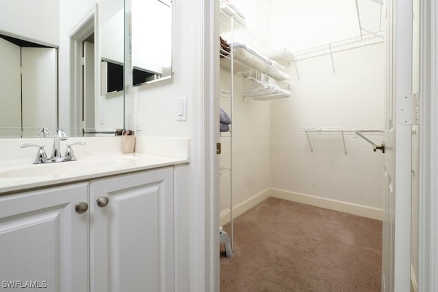 704 107th Ave N, Naples, FL 34108 - spacious closet featuring light carpet and a sink