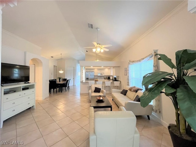 704 107th Ave N, Naples, FL 34108 - living room with arched walkways, light tile patterned floors, crown molding, vaulted ceiling, and ceiling fan