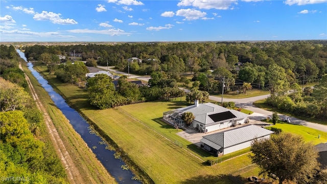 drone / aerial view featuring a water view and a view of trees