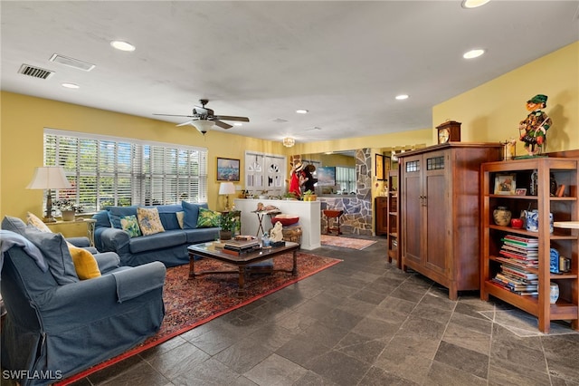 living area featuring recessed lighting, stone finish flooring, visible vents, and ceiling fan