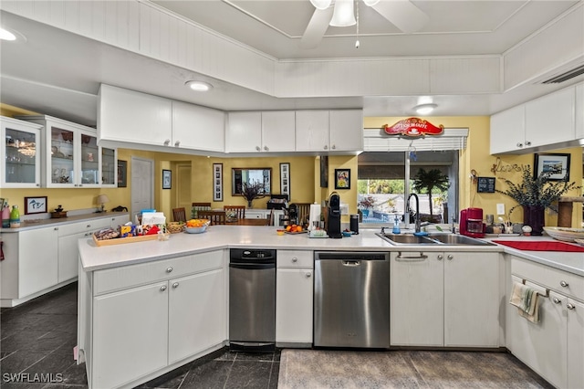 kitchen with a peninsula, light countertops, granite finish floor, white cabinetry, and a sink