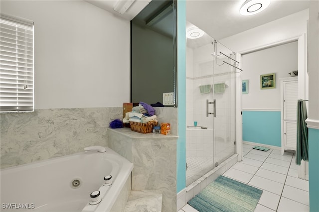 bathroom featuring a jetted tub, a stall shower, and tile patterned flooring