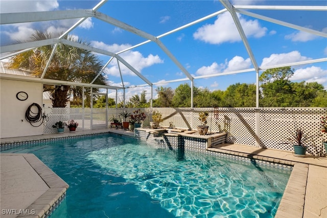 view of pool featuring glass enclosure and a fenced in pool