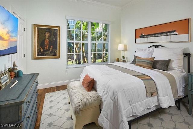 bedroom with crown molding and wood-type flooring