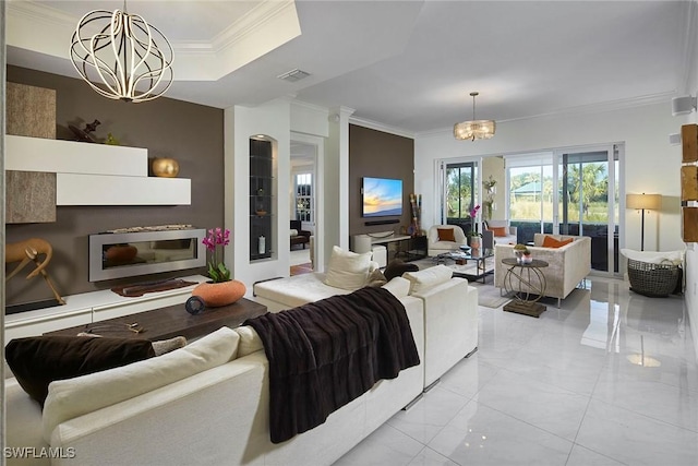 living room featuring ornamental molding and a chandelier