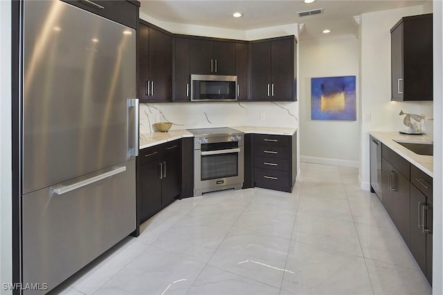 kitchen featuring sink, tasteful backsplash, crown molding, dark brown cabinets, and stainless steel appliances