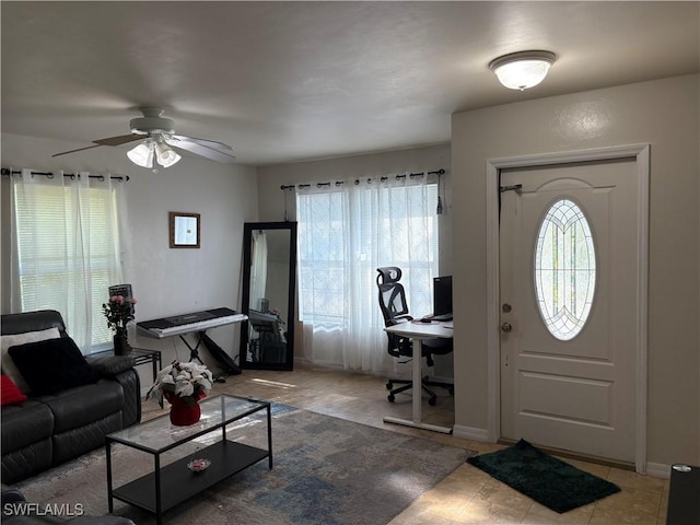 entrance foyer featuring plenty of natural light, ceiling fan, and baseboards