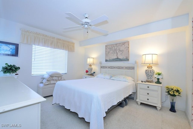 bedroom featuring light colored carpet and ceiling fan