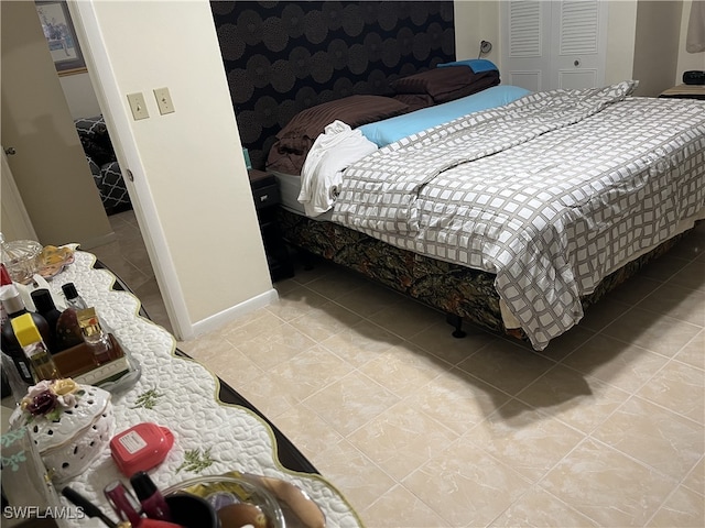 tiled bedroom featuring a closet