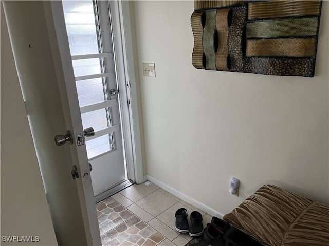 doorway featuring light tile patterned flooring