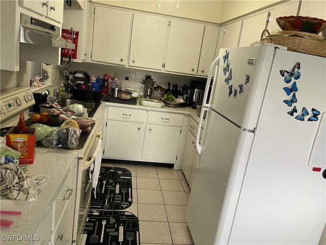 kitchen featuring light tile patterned flooring, backsplash, white appliances, and cream cabinetry