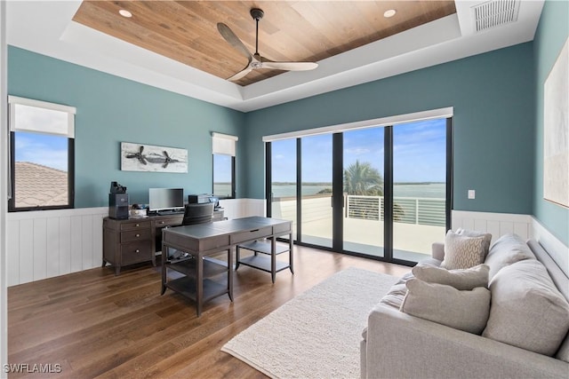 office featuring hardwood / wood-style flooring, wooden ceiling, ceiling fan, and a tray ceiling