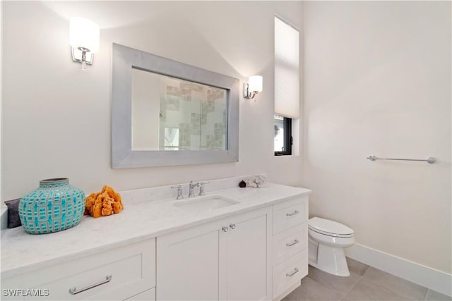 bathroom featuring vanity, tile patterned floors, and toilet