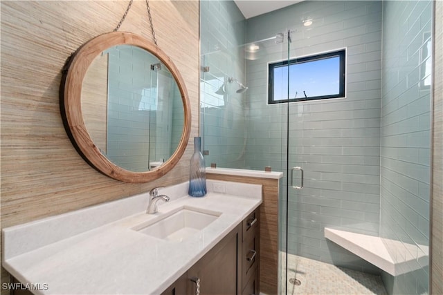 bathroom with vanity and a shower with shower door