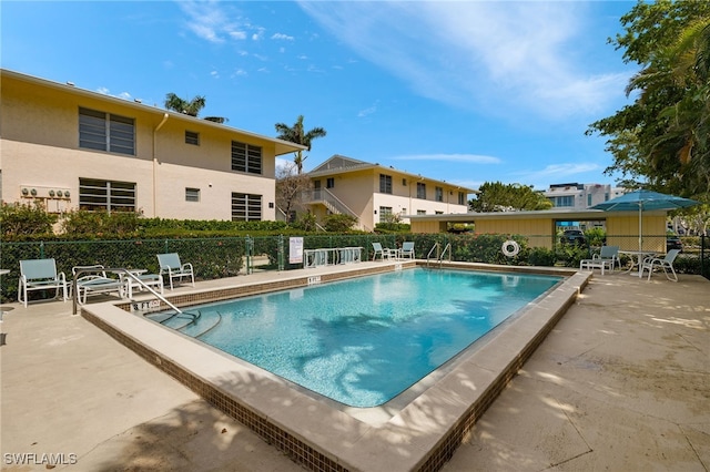 pool featuring a patio area and fence