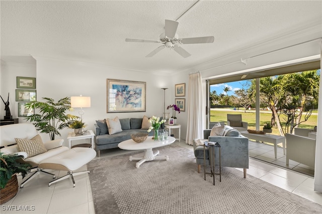 living room with light tile patterned floors, ornamental molding, and a textured ceiling