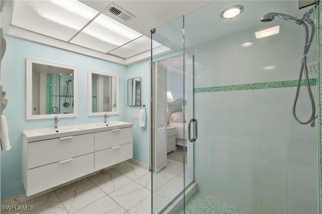 full bathroom with double vanity, a stall shower, visible vents, marble finish floor, and a sink