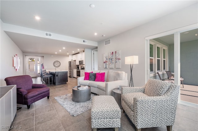 living area featuring recessed lighting, visible vents, and light tile patterned flooring