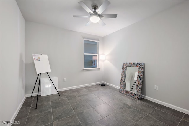 unfurnished room featuring ceiling fan, tile patterned flooring, and baseboards