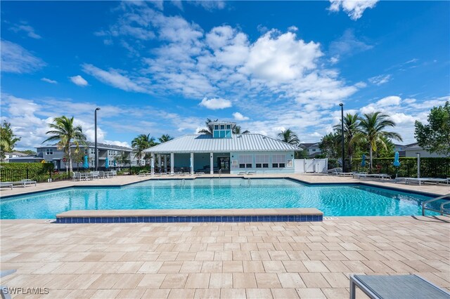 pool featuring a patio area and fence