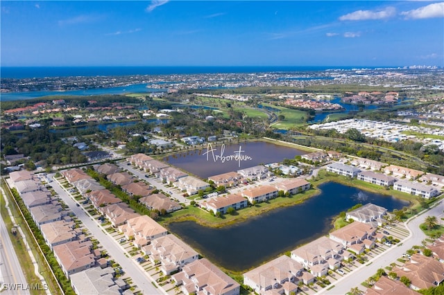 drone / aerial view featuring a residential view and a water view