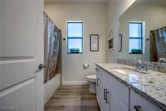 full bathroom with vanity, shower / bath combination with curtain, and toilet