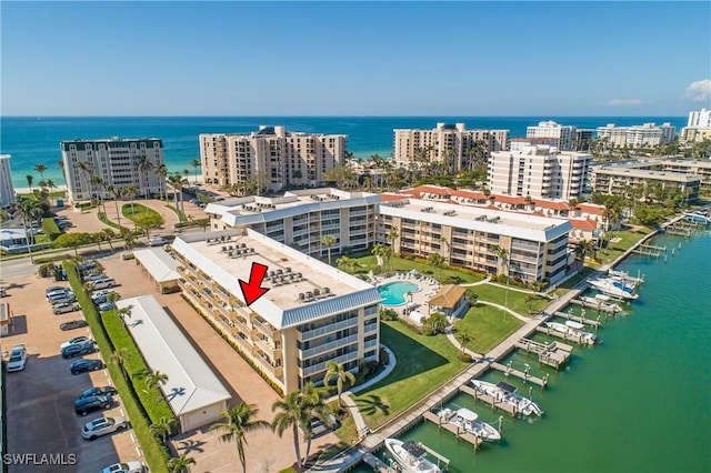 drone / aerial view featuring a water view and a city view