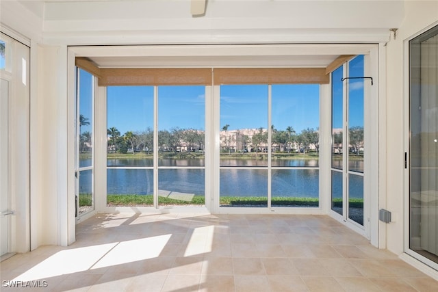 unfurnished sunroom with a water view