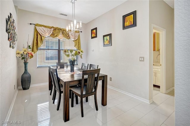 dining space with light tile patterned floors and a notable chandelier