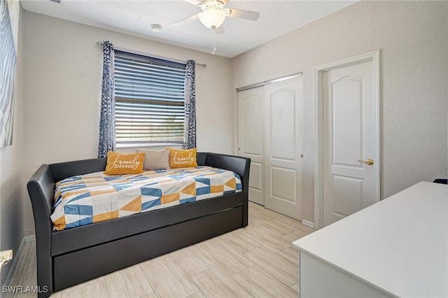 bedroom with ceiling fan and a closet