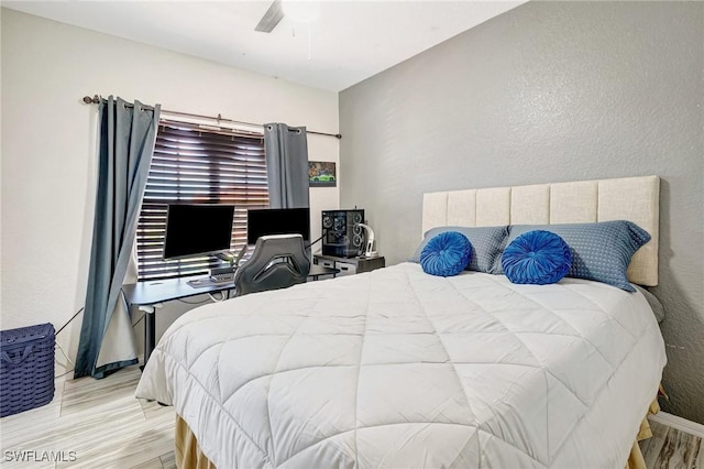 bedroom with ceiling fan and light hardwood / wood-style flooring