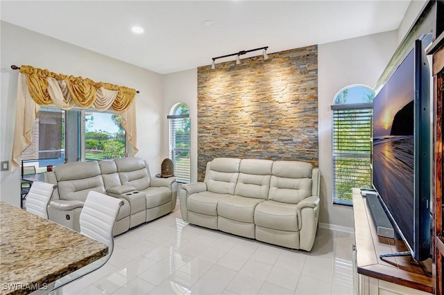 tiled living room featuring rail lighting