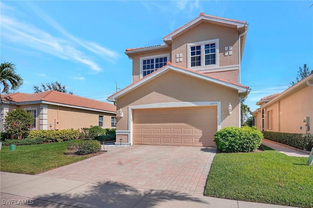 view of front facade with a garage and a front yard