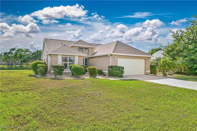 view of front of home featuring a garage and a front lawn