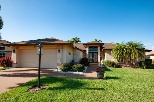 prairie-style home with a garage, concrete driveway, french doors, stucco siding, and a front lawn