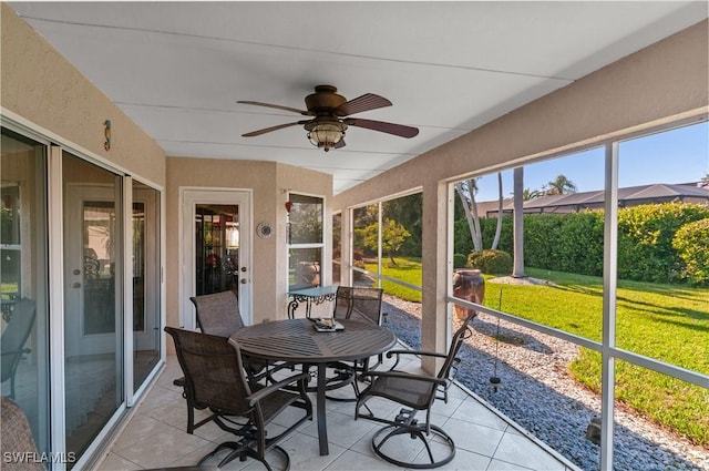 sunroom featuring a ceiling fan