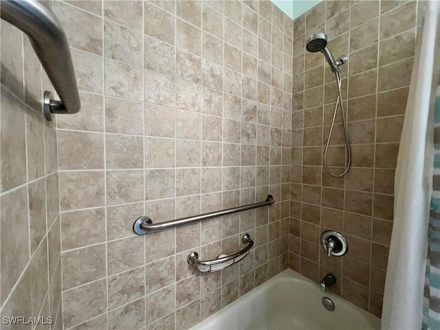 bathroom with shower / bath combo with shower curtain