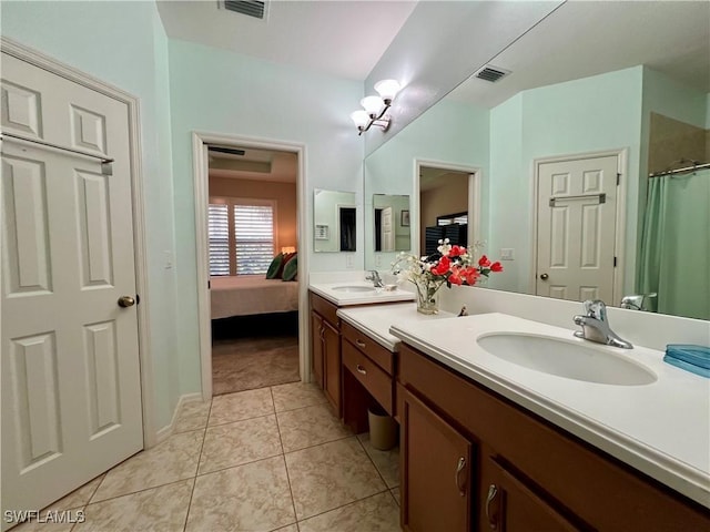 bathroom with tile patterned floors and vanity