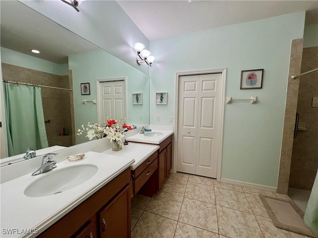 bathroom with tile patterned floors, curtained shower, and vanity