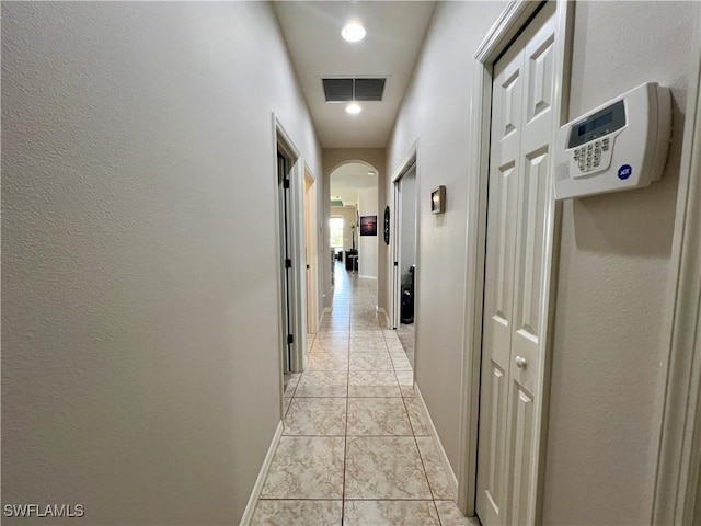 hallway featuring light tile patterned floors